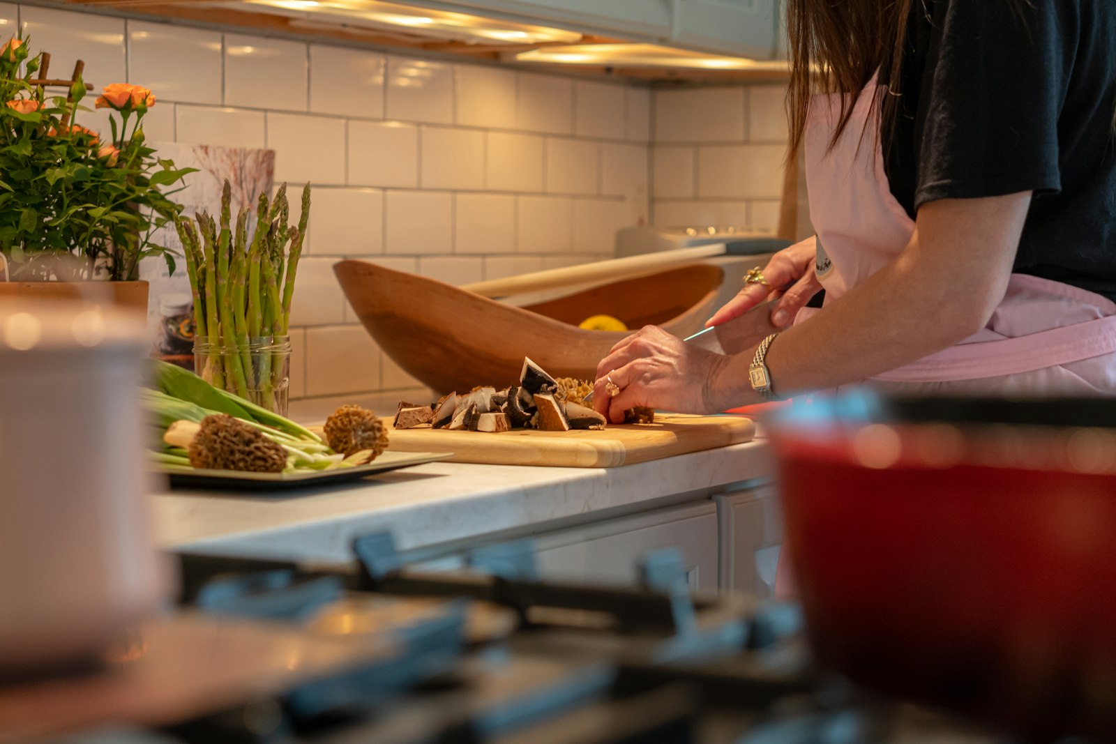 A person preparing fresh vegetables in a kitchen
